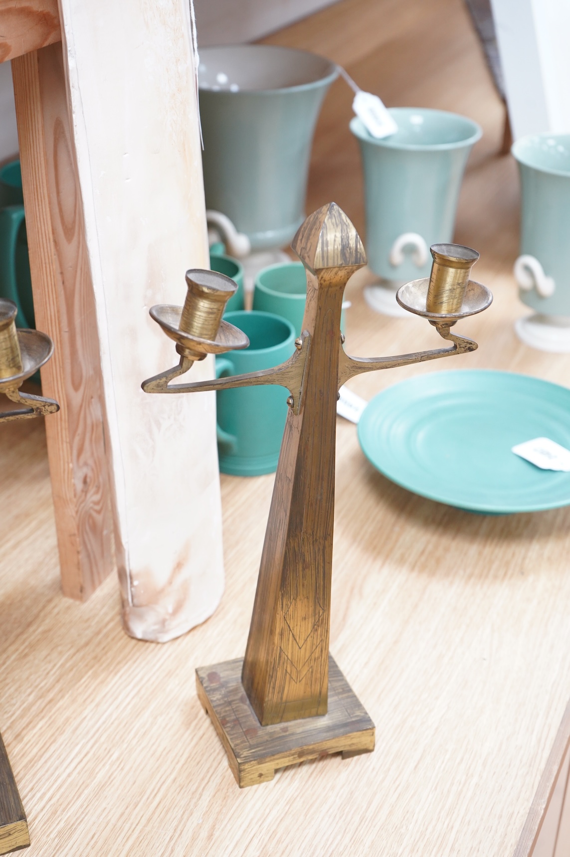 A pair of Jugendstil Arts and Crafts brass two branch candelabra, 37cm high